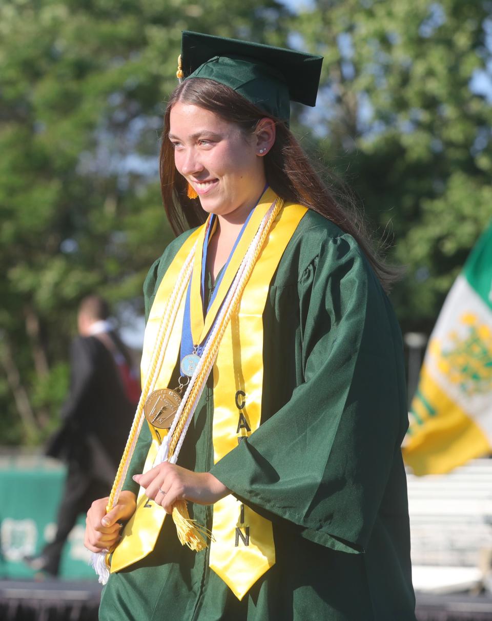 St. Vincent-St. Mary valedictorian Anne Rea smiles during the school's commencement ceremony Tuesday at Green Street Stadium in Akron.