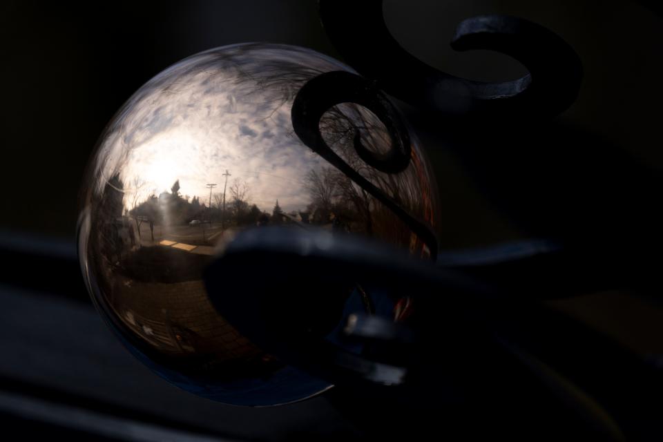 Brass spheres sit atop the 100-year-old metal archway at Rawson Woods Bird Preserve were dark with oxidation when Steve Mergner rescued the fallen structure three years ago.