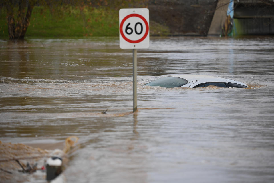 A car is seen submerged by flood water in Traralgon, Victoria, Thursday, June 10, 2021.