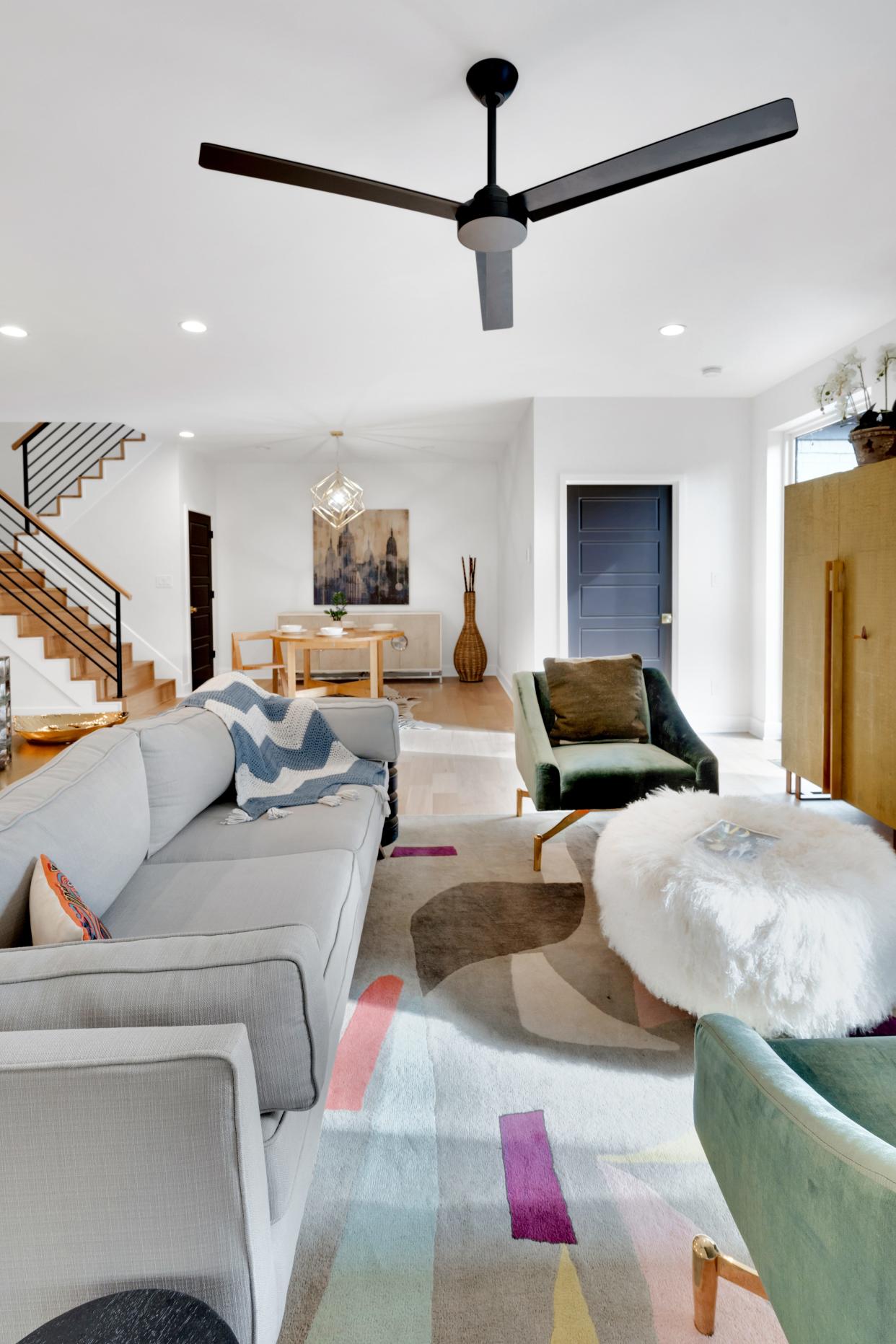 A multi-hued rug and various pieces of furniture bring color and texture into the living room inside this home in Louisville’s Rivers Edge subdivision.