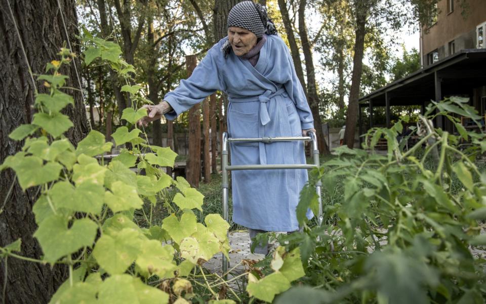 Nina, 90, displaced from Saltivka district in Kharkiv, cares of her garden