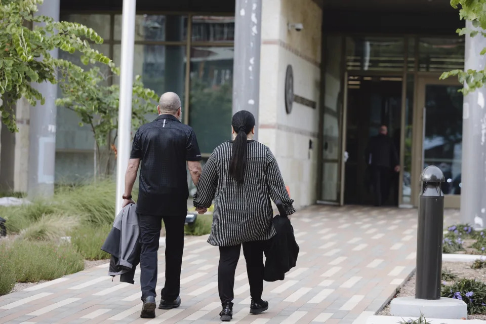 Janet Yamanaka Mello, right, an ex-civilian employee of the U.S. Army convicted of stealing $109 million from a youth development program for children of military families, and her husband, Mark Mello, walk into the federal courthouse Tuesday, July 23, 2024, in San Antonio, Texas. (Christopher Lee/The San Antonio Express-News via AP)