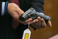 A Glock 21 handgun is shown during the murder trial for former NFL player Aaron Hernandez at the Bristol County Superior Court in Fall River, Massachusetts, March 11 2015. REUTERS/Dominick Reuter/Pool (UNITED STATES - Tags: CRIME LAW SPORT FOOTBALL)