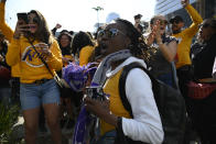 Jai Jai Wesley cheers outside of the Staples Center during a public memorial for former Los Angeles Lakers star Kobe Bryant and his daughter, Gianna, in Los Angeles, Monday, Feb. 24, 2020. (AP Photo/Kelvin Kuo)