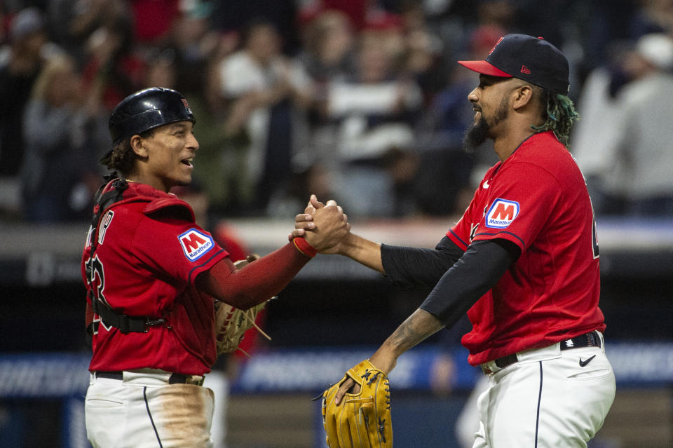 Cleveland Guardians' Bo Naylor, left, congratulates teammate Emmanuel Clase, right, after a win over the Texas Rangers in at a baseball game in Cleveland, Saturday, Sept. 16, 2023. (AP Photo/Phil Long)