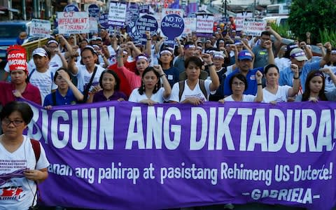 Protesters mark International Women's Day in downtown Manila, calling Philippine President Rodrigo Duterte among the worst violators of women's rights in Asia - Credit: Bullit Marquez/AP