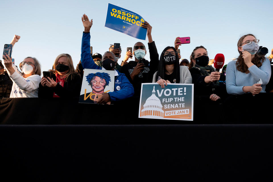 Supporters of democratic candidates for Senate Jon Ossoff and Raphael Warnock listen to President-elect Joe Biden speak during a rally in Atlanta, on Jan. 4, 2021.<span class="copyright">Jim Watson—AFP/Getty Images</span>