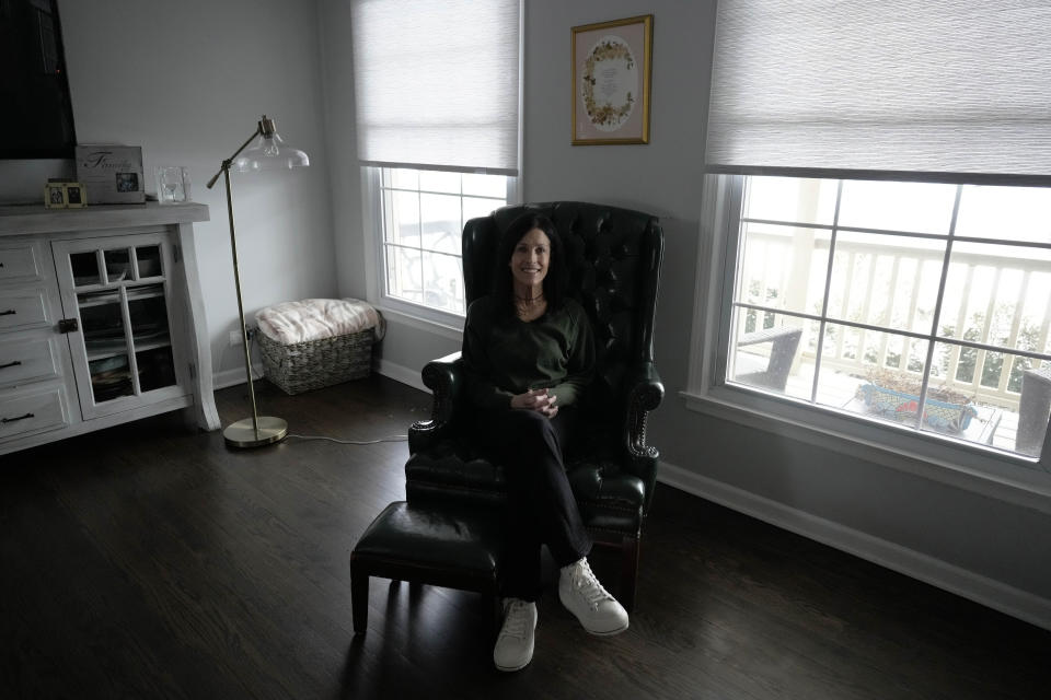 Jill Feldman, 54, poses for a photo at her home in Deerfield, Ill., Friday, Jan. 19, 2024. Lung cancer patient and advocate Jill Feldman takes pills at home that shrink tumors by blocking a signal that tells cancer cells to grow. (AP Photo/Nam Y. Huh)