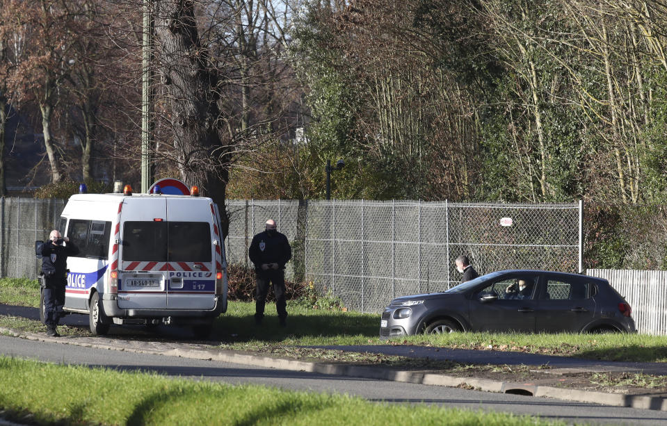 Police officers guard La Lanterne, a presidential residence in Versailles, outside Paris, Friday, Dec. 18, 2020 in Paris. As French President Emmanuel Macron rides out the coronavirus in a presidential retreat at Versailles, French doctors are warning families who are heading for the holidays to remain cautious because of an uptick in infections — especially at the dinner table. (AP Photo/Michel Euler)