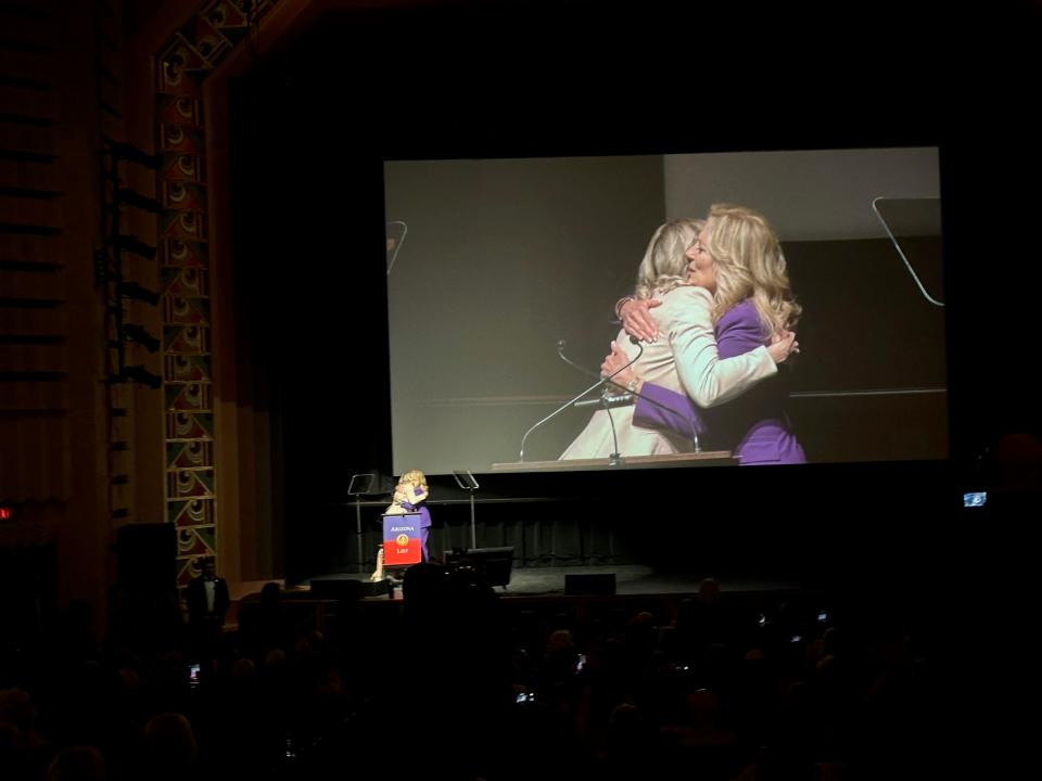 First lady Jill Biden embraces OB-GYN Danielle Allen Herried at Tucson's Fox Theatre.