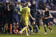 Nashville SC's Walker Zimmerman, center, looks back as the Philadelphia Union celebrates their win following the shootout of an MLS playoff soccer match, Sunday, Nov. 28, 2021, in Chester, Pa. The Union won 2-0 in the penalty kick shootout after tying 1-1 in regulation time. (AP Photo/Chris Szagola)