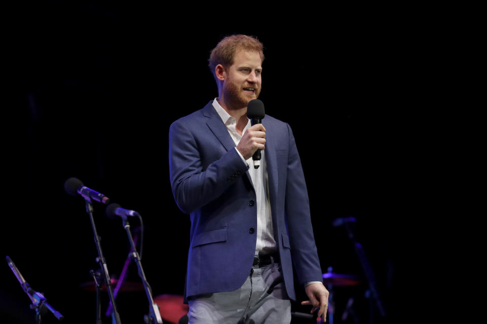 Britain's Prince Harry speaks on stage during a concert hosted by his charity Sentebale at Hampton Court Palace, in London, Tuesday June 11, 2019. The concert will raise funds and awareness for Sentebale, the charity founded by Prince Harry and Lesotho's Prince Seeiso in 2006, to support children and young people affected by HIV and AIDS in Lesotho, Botswana and Malawi. (AP Photo/Matt Dunham, Pool)