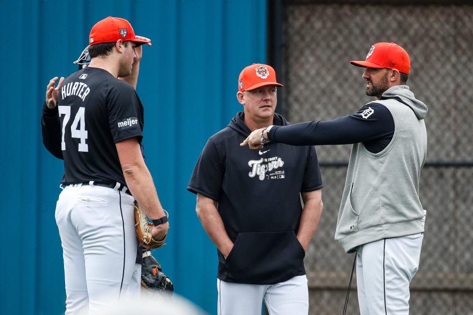 Detroit Tigers manager A.J. Hinch and director of pitching Gabe Ribas talk to pitcher Brant Hurter during spring training at TigerTown in Lakeland, Fla. on Saturday, Feb. 17, 2024.