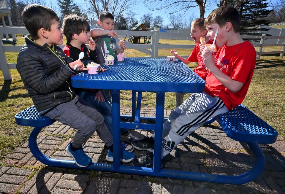 WESTBOROUGH - On the first day of spring, which also happened to be his 8th birthday, Pierce O'Donnell, center, and his friends Walker, left, Beckett, right, Jake, right front and Sam right back, enjoy cones in cups at Uhlman's Ice Cream. All are from Hopkinton. Uhlman's opened March 3.