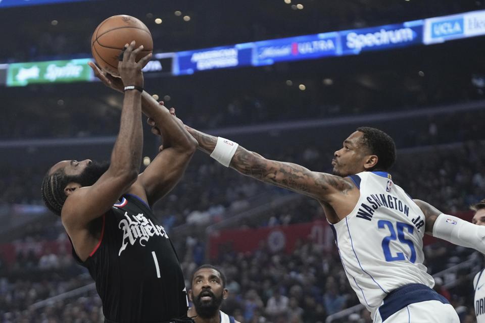 Los Angeles Clippers guard James Harden, left, shoots as Dallas Mavericks forward P.J. Washington defends during the first half in Game 2 of an NBA basketball first-round playoff series Tuesday, April 23, 2024, in Los Angeles. (AP Photo/Mark J. Terrill)