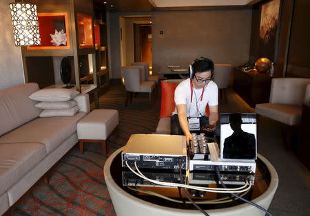 An invited guest enjoys a private listening experience of a test unit of the Sennheiser HE 1 sound system, which is expected to retail for about S$77370 ($55000), in a hotel suite during the CanJam headphone and personal audio expo in Singapore February 21, 2016. REUTERS/Edgar Su