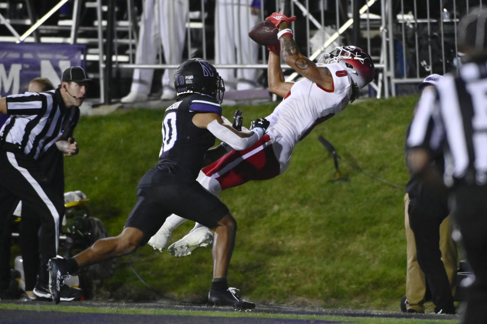 Miami (Ohio) wide receiver Mac Hippenhammer (0) can't hold on to the ball while being covered by Northwestern defensive back Theran Johnson (10) during the second half of an NCAA college football game Saturday, Sept. 24, 2022, in Evanston, Ill. (AP Photo/Matt Marton)