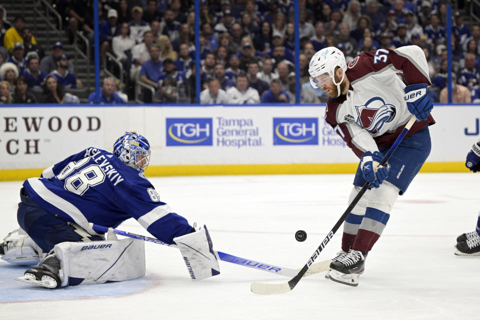 Tampa Bay Lightning goaltender Andrei Vasilevskiy (88) deflects a shot by Colorado Avalanche left wing J.T. Compher (37) during the second period of Game 6 of the NHL hockey Stanley Cup Finals on Sunday, June 26, 2022, in Tampa, Fla. (AP Photo/Phelan Ebenhack)