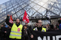 Striking employees demonstrate outside the Louvre museum Friday, Jan. 17, 2020 in Paris. Paris' Louvre museum was closed Friday as dozens of protesters blocked the entrance to denounce the French government's plans to overhaul the pension system. (AP Photo/Francois Mori)