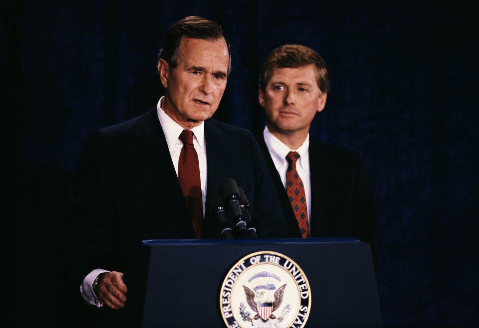 Bush and a youthful Quayle stand at a lectern in dark suits with red ties