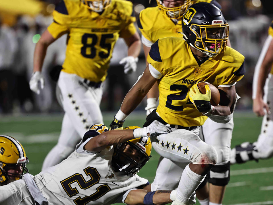Moeller running back Jordan Marshall (24) breaks the tackle of Springfield's Teryon Holt (21) during the Crusaders' state semifinal against Springfield Friday, Nov. 25. Marshall was Co-Offensive Player of the Year in Ohio Division I.