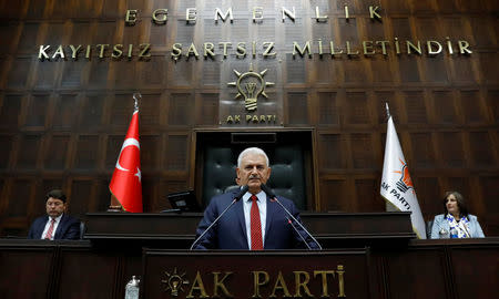 Turkey's Prime Minister Binali Yildirim addresses members of parliament from his ruling AK Party (AKP) during a meeting at the Turkish parliament in Ankara, Turkey, April 18, 2017. REUTERS/Umit Bektas