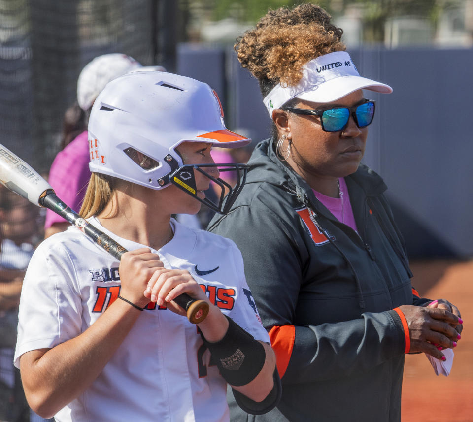 Illinois coach Tyra Perry chats with Stevie Meade (24) during the team's NCAA college softball game against Michigan State on Friday, April 21, 2023, in Urbana, Ill. (Robin Scholz/The News-Gazette via AP)