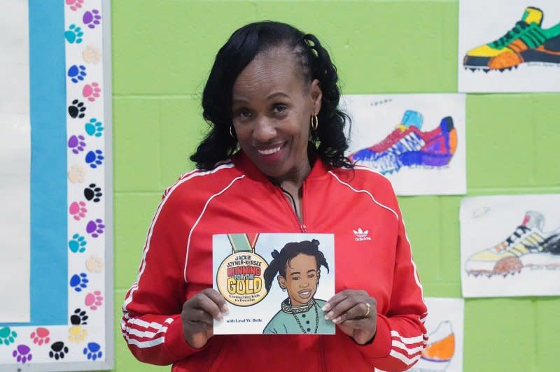 Olympic medalist Jackie Joyner-Kersee shows off her new book "Running for the Gold," at the Wilkinson Early Childhood Center in St. Louis on February 24, 2023. She turns 62 on March 3. File Photo by Bill Greenblatt/UPI