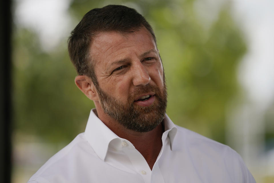 U.S. Rep. Markwayne Mullin, candidate in the Oklahoma Republican Primary runoff election for U.S. Senate, speaks with the media outside a luncheon Tuesday, Aug. 23, 2022, at a luncheon in Norman, Okla. (AP Photo/Sue Ogrocki)