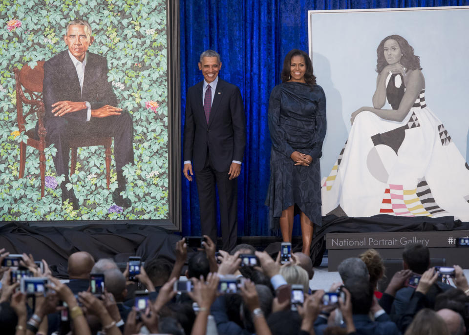 Barack and Michelle Obama with their portraits. (Photo: SAUL LOEB via Getty Images)