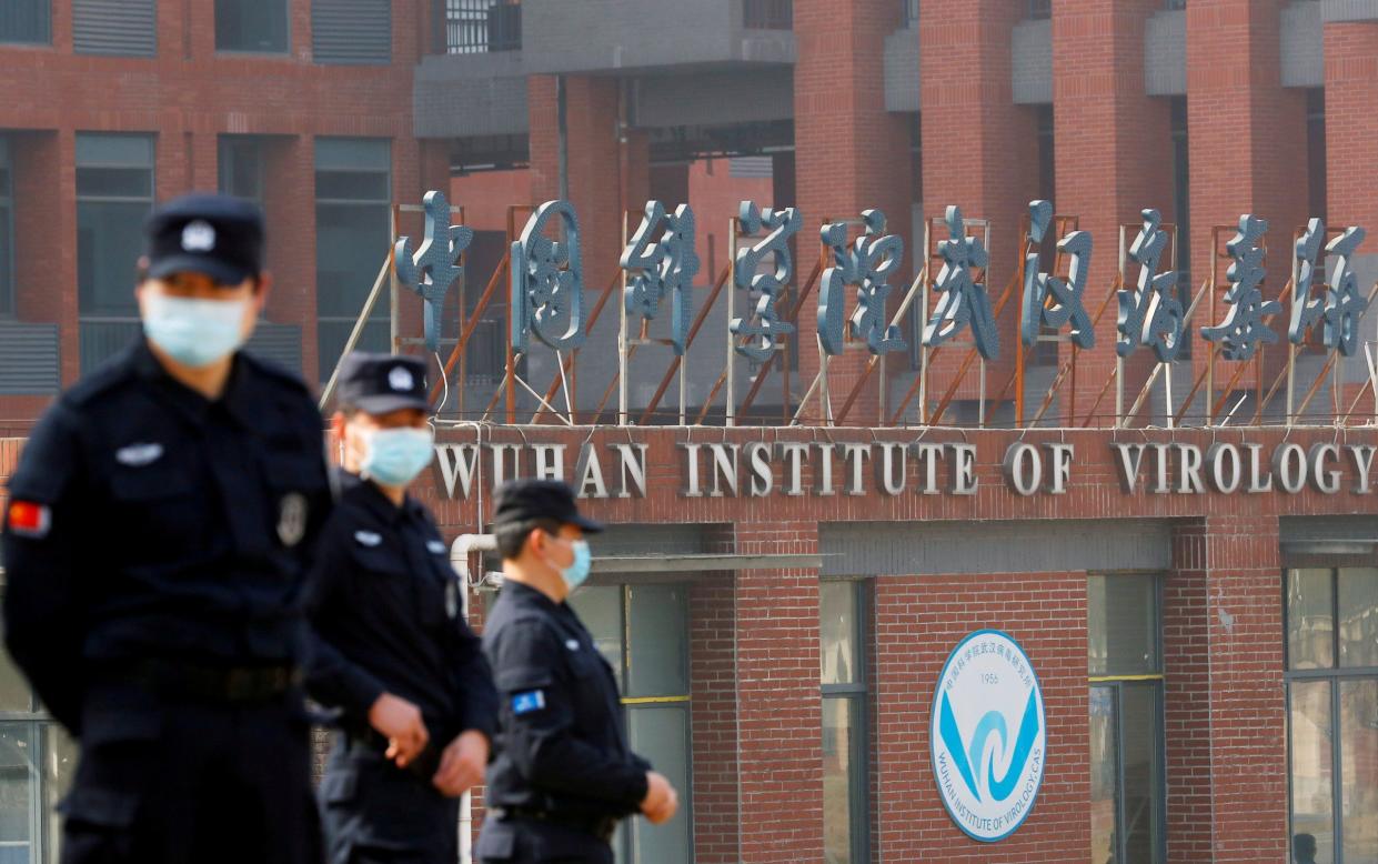 Security personnel keep watch outside the Wuhan Institute of Virology