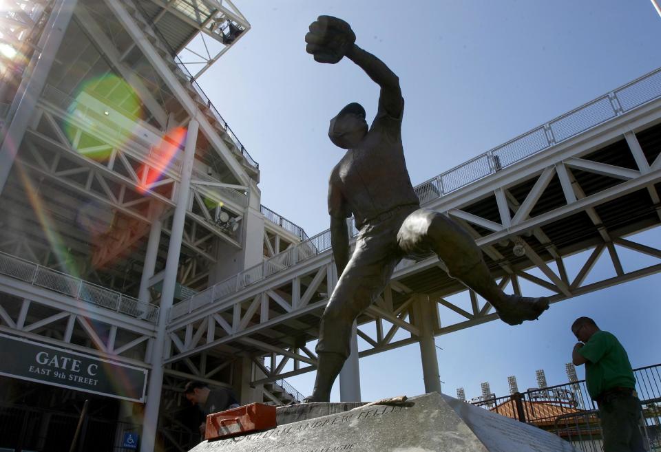 Workers install new commemorative tiles around the base of the Bob Feller statue at Progressive Field, home of baseball's Cleveland Indians, in Cleveland on Wednesday, March 28, 2012. Opening day for the Indians is April 5. (AP Photo/Amy Sancetta)