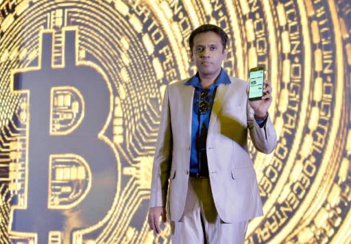 (FILES) In this file photo taken on January 16, 2017 Indian Belfrics CEO Praveen Kumar poses for a photograph at a press conference during the launch of the firms's Indian Bitcoin exchange operations in Bangalore on January 16, 2017. From its birth in an anonymous paper in 2008 to growth into one of the world's most volatile and closely watched financial instruments in 2018, bitcoin has lived through a tumultuous first 10 years