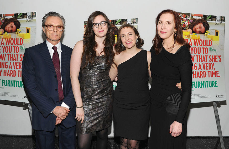 Right: Dunham (second from right) with her family — from left, father Carroll, sibling Cyrus, who came out as transgender in 2019, and mother Laurie Simmons — at the 2010 premiere of her breakout film Tiny Furniture. - Credit: Jamie McCarthy/WireImage