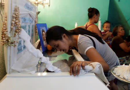 Jennelyn Olaires, 26, looks at the body of her partner Michael Siaron during his wake in Pasay, Metro Manila, Philippines July 28, 2016. REUTERS/Czar Dancel