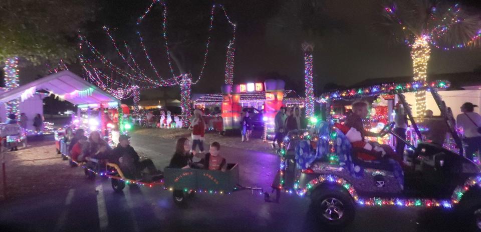 Kids ride the little train through the Christmas lights and decorations, Wednesday, Dec. 21, 2022, at the Twi-Light II Motel in Holly Hill. “It’s consistently beautiful, it’s always well done,” said local Ginger Mason as she reminded her child to keep their feet inside the train as it toured the grounds. “It’s just good for kids. You get out and walk; you don’t have to drive through, which is nice. It’s beautiful, and it’s just down the street. We love it.”