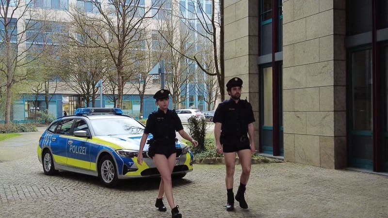 A still image from a YouTube video by the police union (DPolG) shows police officers without pants to denounce the blatant lack of uniforms in the Bavarian police force. -/DPolG Bayern/dpa