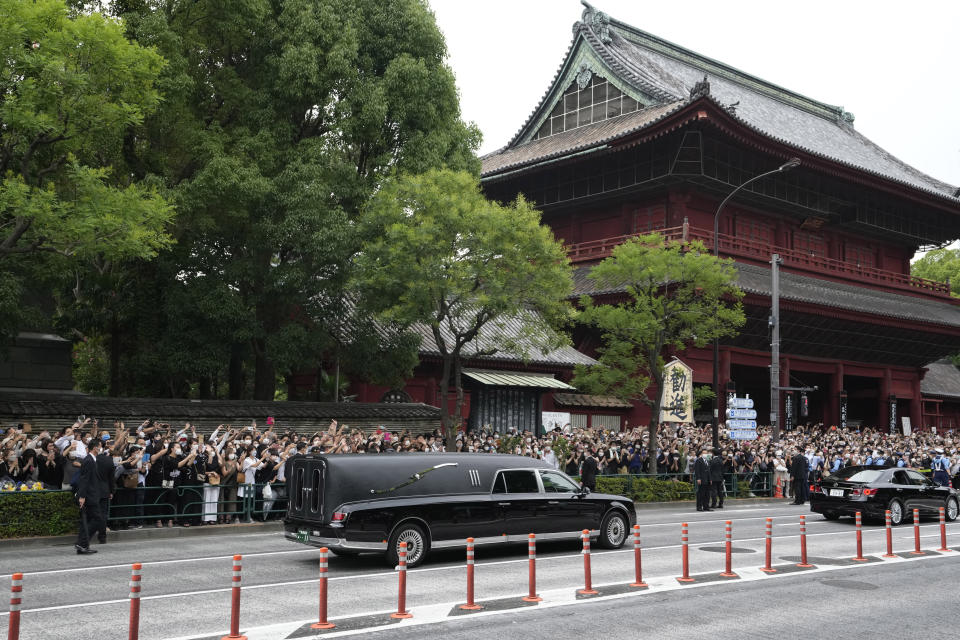 The vehicle carrying the body of former Japanese Prime Minister Shinzo Abe leaves Zojoji temple after his funeral in Tokyo on Tuesday, July 12, 2022. Abe was assassinated Friday while campaigning in Nara, western Japan. (AP Photo/Hiro Komae)