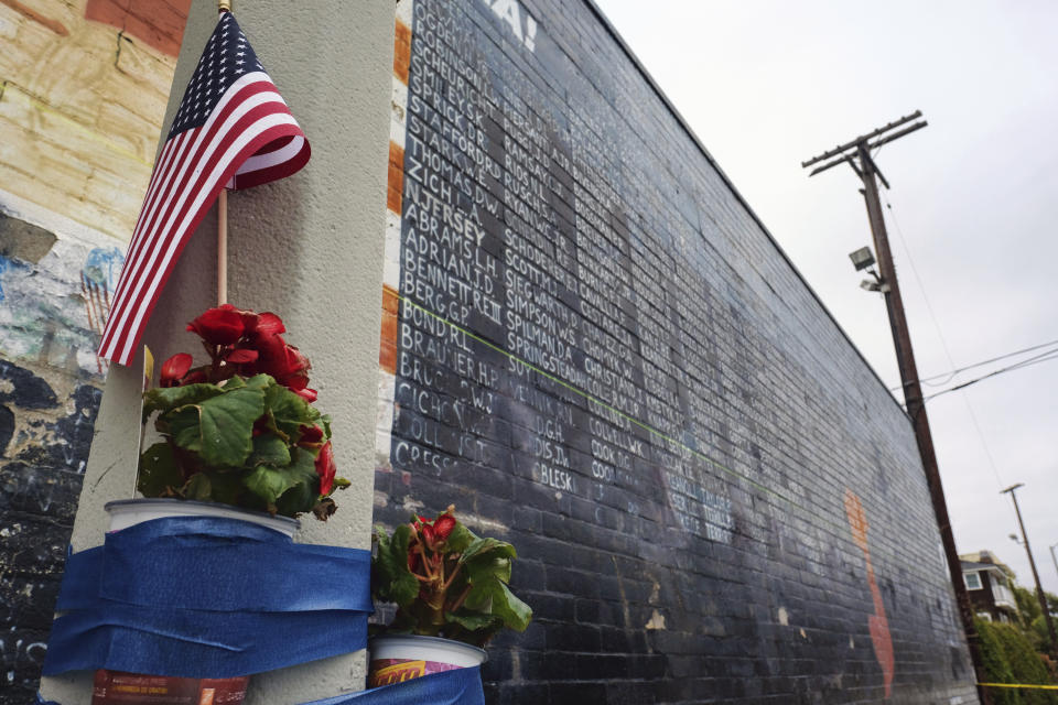 FILE - This Monday, May 30, 2016 file photo shows flowers left next to a vandalized Vietnam War memorial in the Venice area of Los Angeles. On Friday, June 5, 2020, The Associated Press reported on stories photos online incorrectly identified as the Vietnam Veterans Memorial in Washington marred by graffiti as a result of riots after the death of George Floyd. The photos circulating on social media are from 2016 and show this Vietnam Veterans Memorial replica in Los Angeles, which was defaced in that year. (AP Photo/Richard Vogel, File)