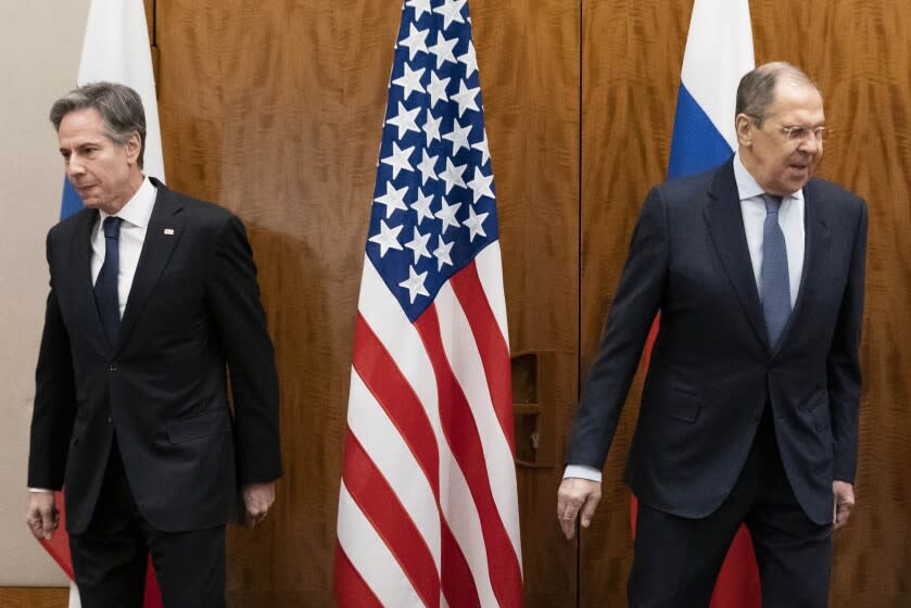 US Secretary of State Antony Blinken, left, and Russian Foreign Minister Sergey Lavrov move to their seats before their meeting, Friday, Jan. 21, 2022, in Geneva, Switzerland. (AP Photo/Alex Brandon, Pool)