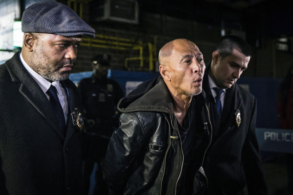 FILE - Weng Sor, center, is walked by New York Police Department detectives out of the 68th Precinct in the Brooklyn borough of New York, on Tuesday, Feb. 14, 2023. Sor, 62, the driver of a U-Haul truck that went on a miles-long rampage, barreling into bicyclists, moped riders, a police car and one pedestrian, was charged with murder in the death of delivery worker YiJie Ye. (AP Photo/Stefan Jeremiah, File)