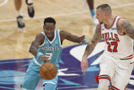 Charlotte Hornets guard Terry Rozier, left, pushes the ball upcourt against Chicago Bulls center Daniel Theis during the first half of an NBA basketball game in Charlotte, N.C., Thursday, May 6, 2021. (AP Photo/Nell Redmond)