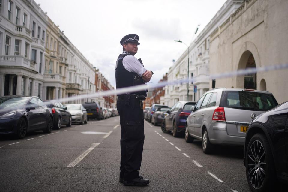 A police officer at the scene in Comeragh Road, West Kensington (Victoria Jones/PA Wire)