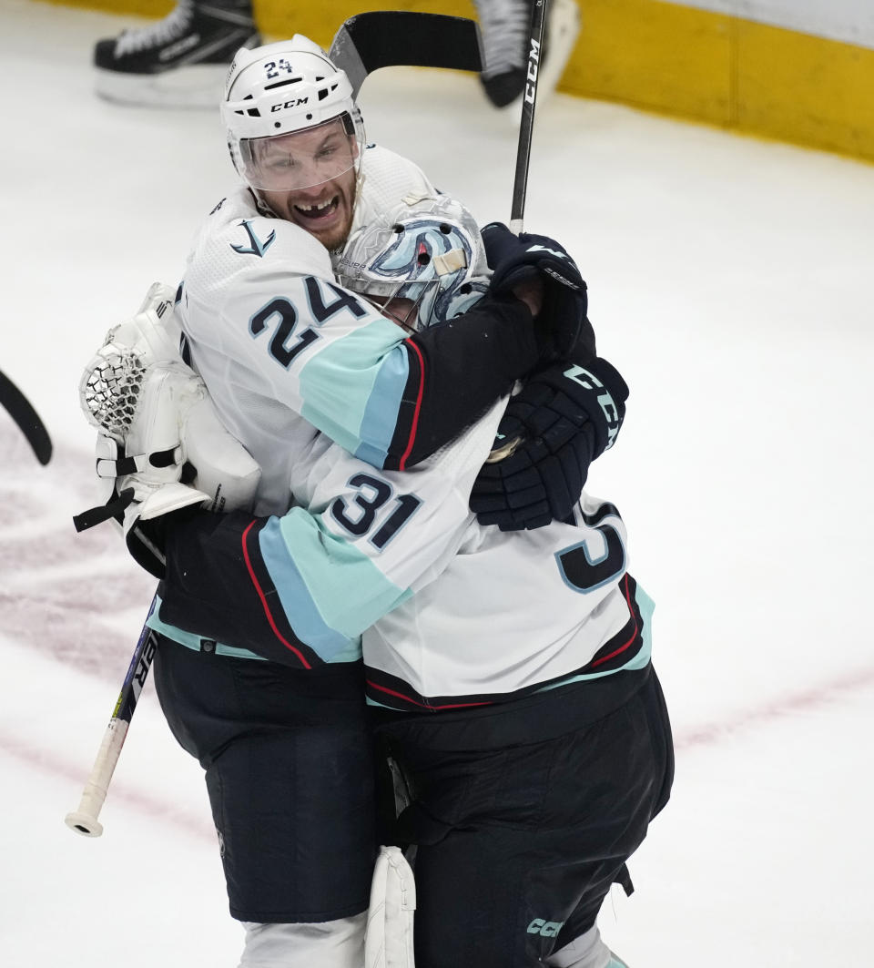 Seattle Kraken defenseman Jamie Oleksiak, left, hugs goaltender Philipp Grubauer as time runs out in the third period of Game 7 of an NHL first-round playoff series against the Colorado Avalanche Sunday, April 30, 2023, in Denver. The Kraken won 2-1 to advance to the next round. (AP Photo/David Zalubowski)