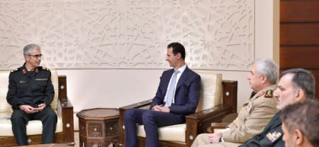 Iran's military chief, General Mohammad Baqeri meets with Syrian President Bashar al-Assad in Damascus, Syria in this handout picture provided by SANA on October 19, 2017. SANA/Handout via REUTERS