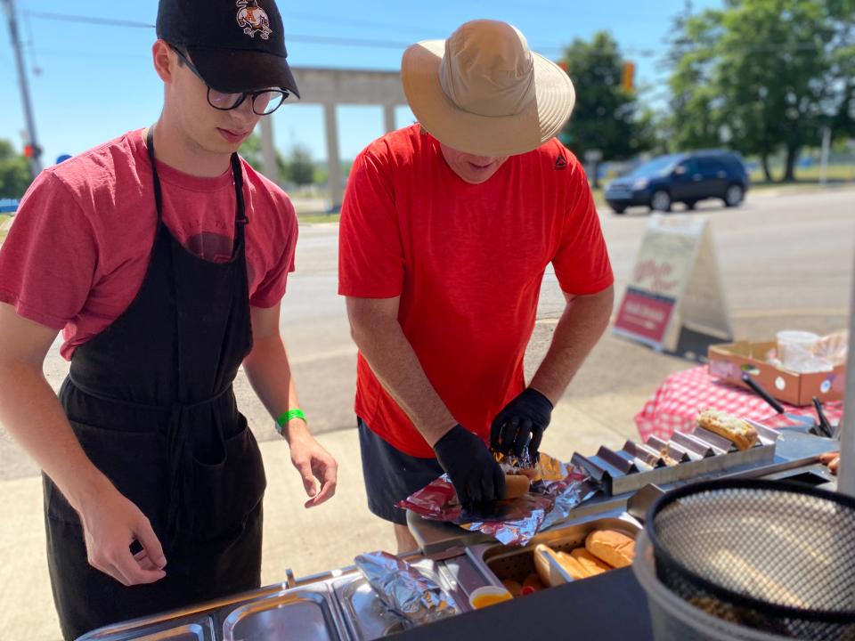James Sirks and Jim Sirks prepare orders at the White Star Coneys stand in the parking lot of Bailey Park Supermarket in Pennfield Township in Thursday, June 30, 2022.