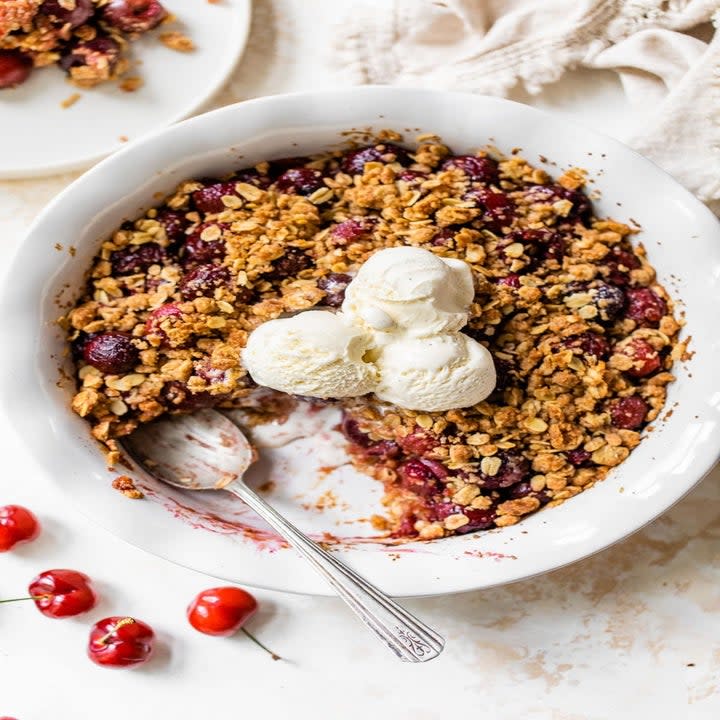 A cherry crisp in a pie dish.