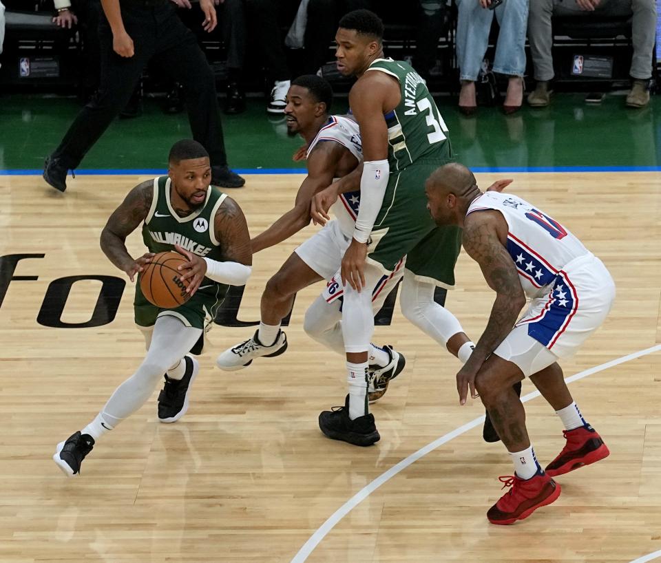 Bucks guard Damian Lillard takes advantage of a screen by Giannis Antetokounmpo against the 76ers in the season opener. It could prove to be an unstoppable combination this season.