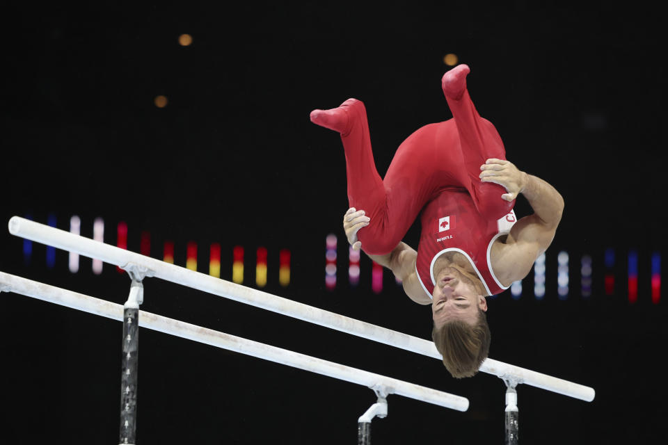 Canada's William Emard competes on the parallel bars during the Men's team final at the Artistic Gymnastics World Championships in Antwerp, Belgium, Tuesday, Oct. 3, 2023. (AP Photo/Geert Vanden Wijngaert)