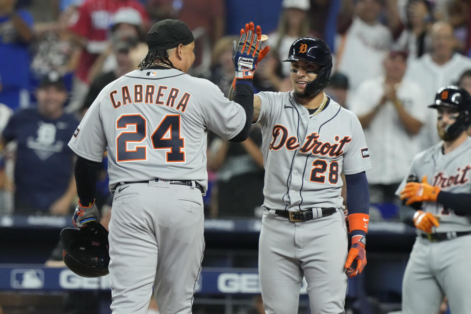 Detroit Tigers' Miguel Cabrera (24) and Javier Baez (28) celebrates after scoring on a home run by Akil Baddoo during the second inning of a baseball game against the Miami Marlins, Saturday, July 29, 2023, in Miami. (AP Photo/Marta Lavandier)